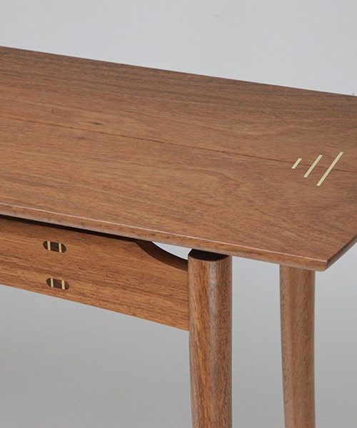 A Brolga Hall Table in jarrah with rock maple highlights