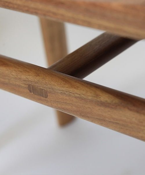 A detail of the low River Stool in blackwood
