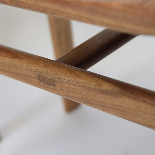 A detail of the low River Stool in blackwood