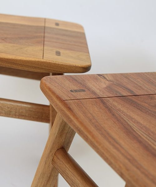 A detail of the low River Stool in blackwood