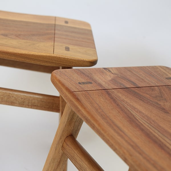 A detail of the low River Stool in blackwood