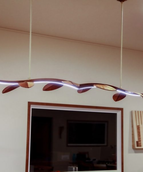 An LED hanging light in blackwood designed and made by the team at Dunstone Design.