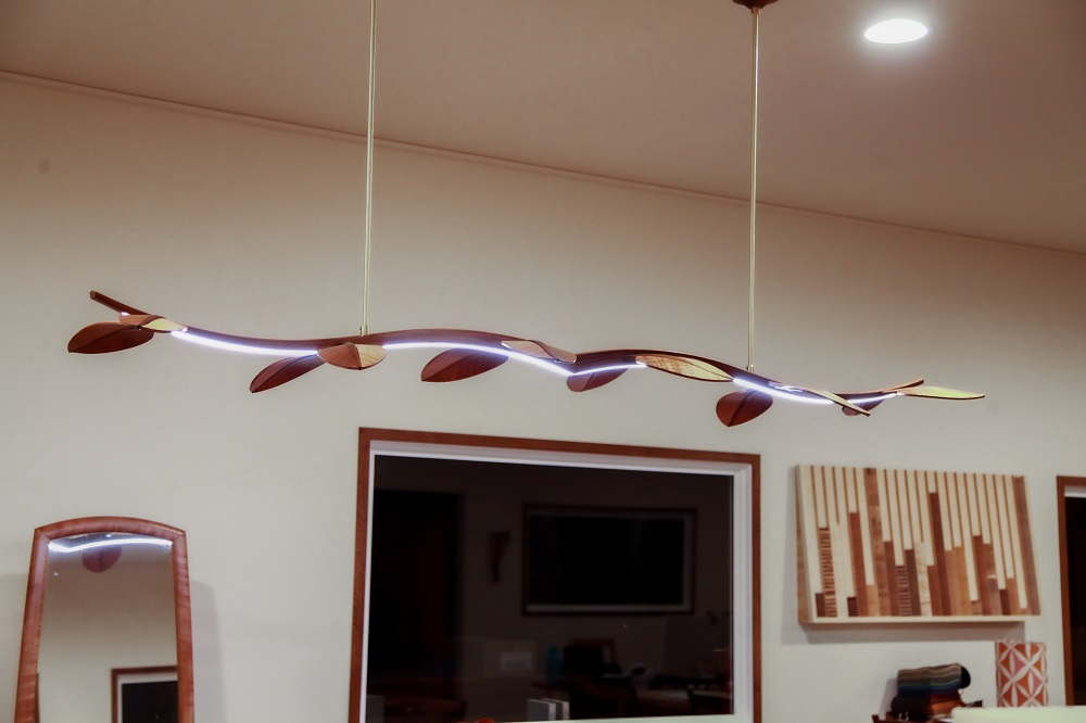 An LED hanging light in blackwood designed and made by the team at Dunstone Design.