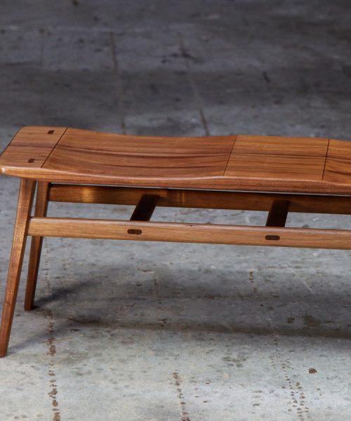 A low two seat stool designed for Australian hallways made from native timbers.