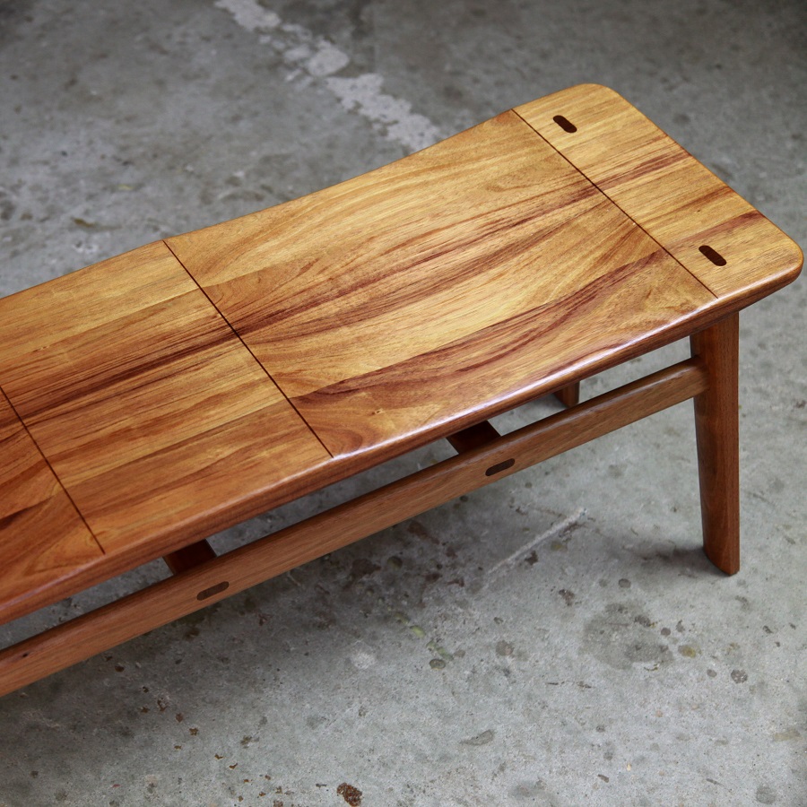 A low two seat stool designed for Australian hallways made from native timbers.