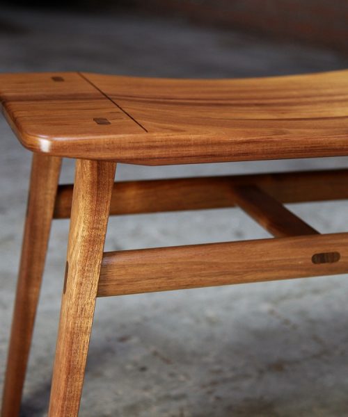 A low two seat stool designed for Australian hallways made from native timbers.