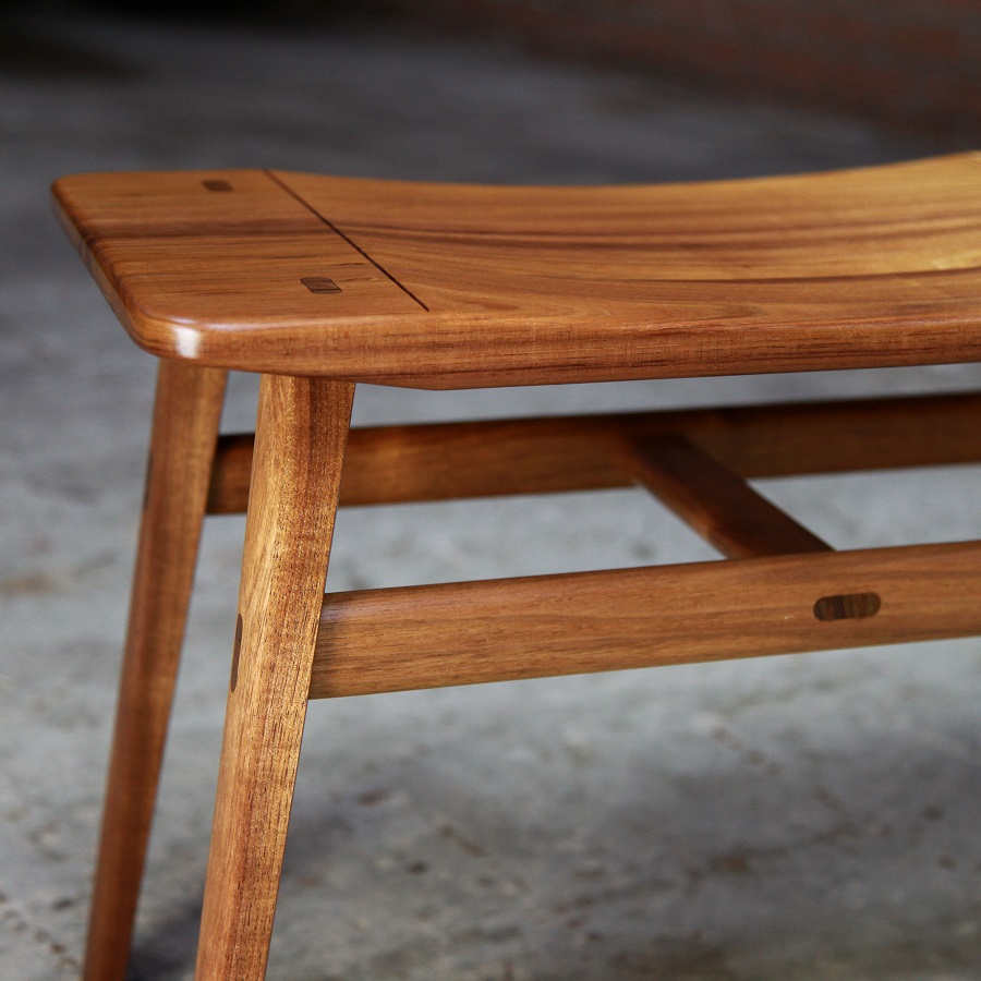 A low two seat stool designed for Australian hallways made from native timbers.