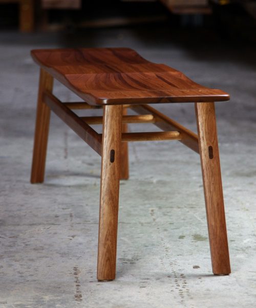 A low two seat stool designed for Australian hallways made from native timbers.