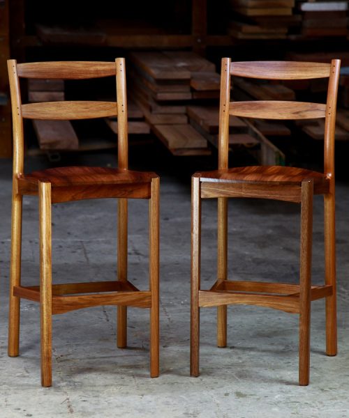 A high stool with a back rest designed for Australian houses and made from native timbers.
