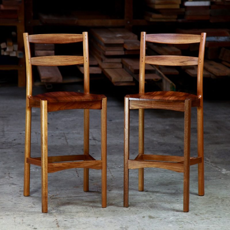 A high stool with a back rest designed for Australian houses and made from native timbers.
