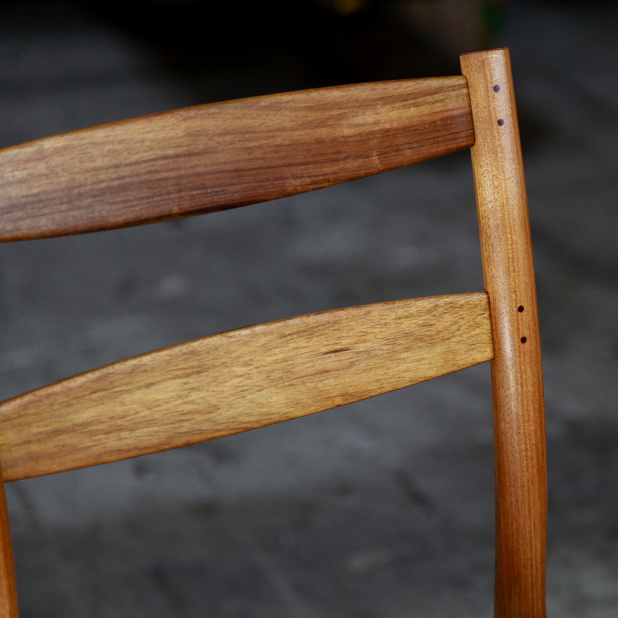 A high stool with a back rest designed for Australian houses and made from native timbers.