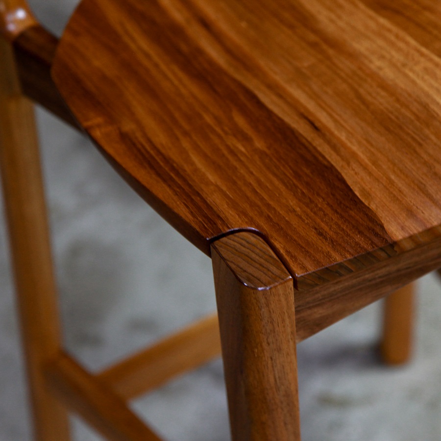 A high stool with a back rest designed for Australian houses and made from native timbers.