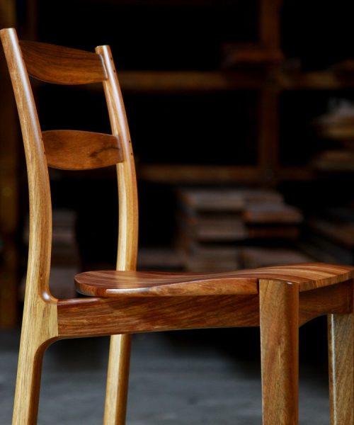 A high stool with a back rest designed for Australian houses and made from native timbers.