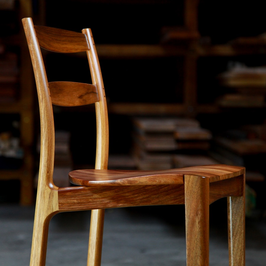 A high stool with a back rest designed for Australian houses and made from native timbers.
