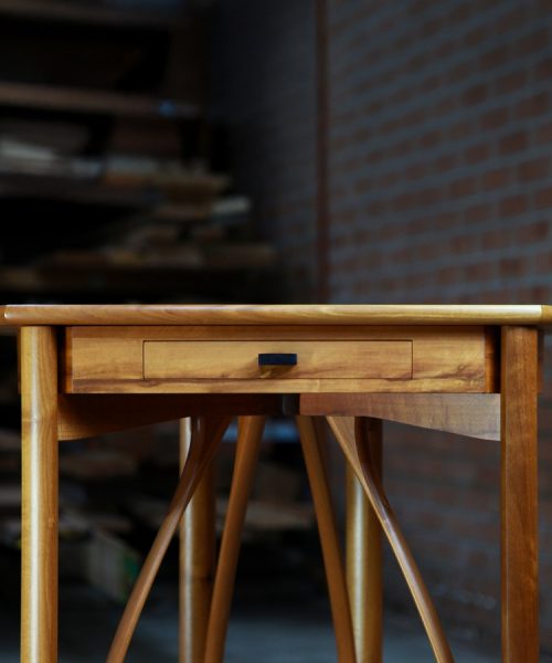 A corner table designed for Australian homes made from native timbers.