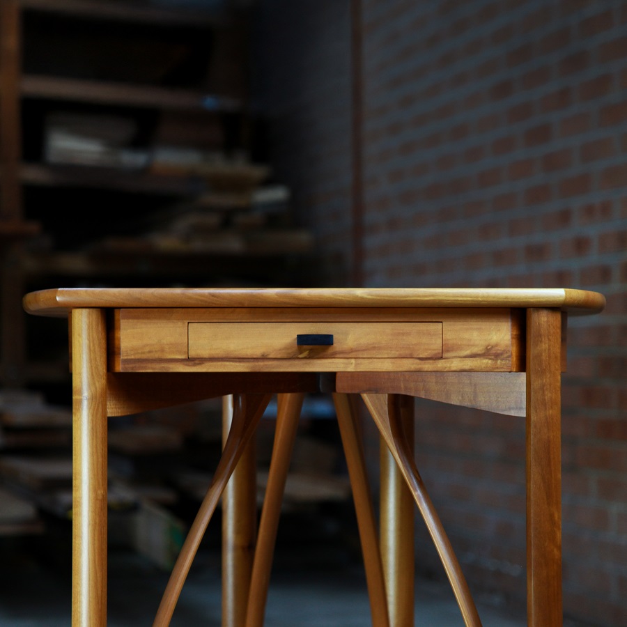 A corner table designed for Australian homes made from native timbers.