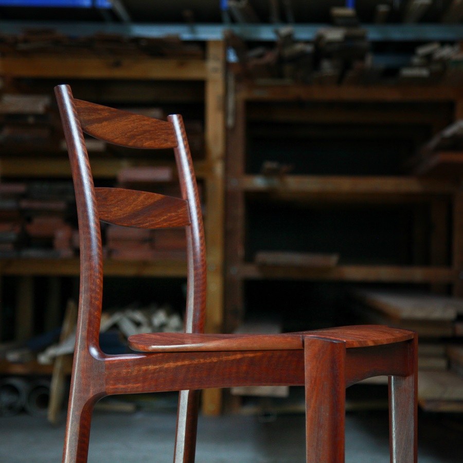 A high stool with a back rest designed for Australian houses and made from native timbers.