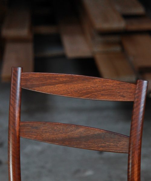 A high stool with a back rest designed for Australian houses and made from native timbers.