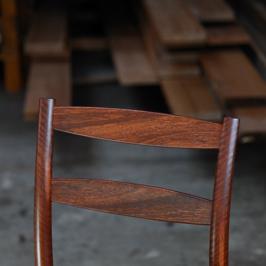 A high stool with a back rest designed for Australian houses and made from native timbers.