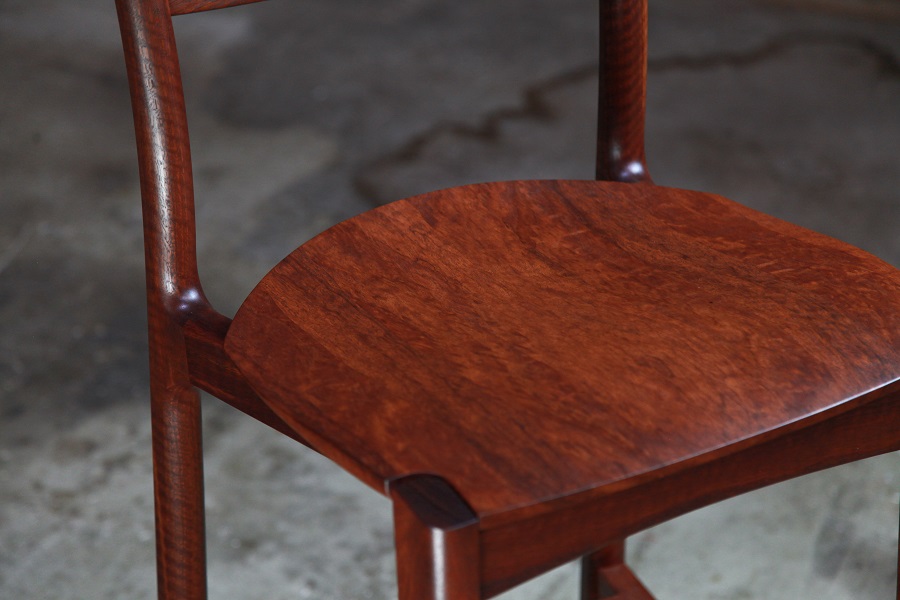 A high stool with a back rest designed for Australian houses and made from native timbers.