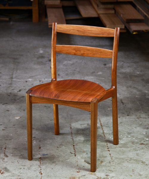 An Australian designed and made low back dining chair in Tasmanian blackwood in a woodworking workshop.