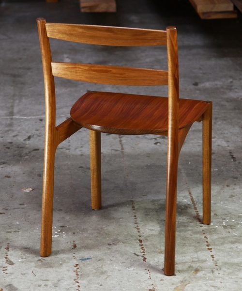 An Australian designed and made low back dining chair in Tasmanian blackwood in a woodworking workshop.