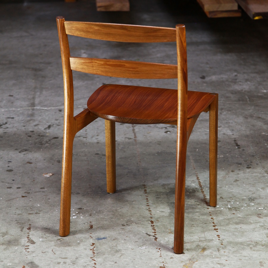An Australian designed and made low back dining chair in Tasmanian blackwood in a woodworking workshop.