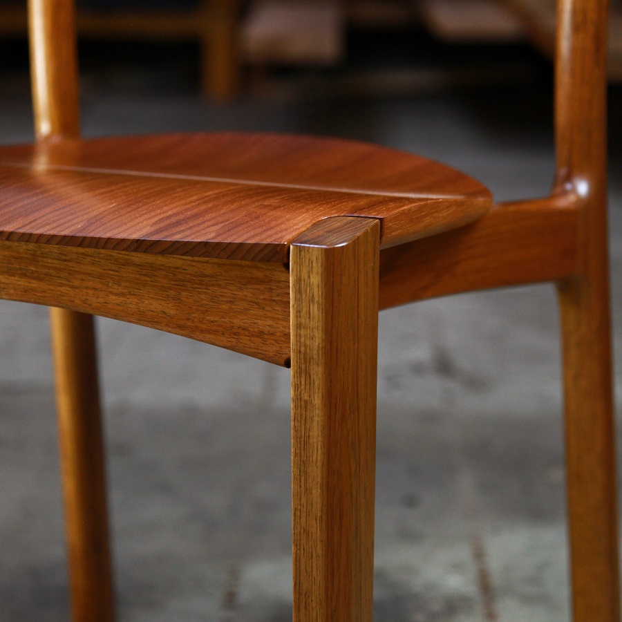 An Australian designed and made low back dining chair in Tasmanian blackwood in a woodworking workshop.