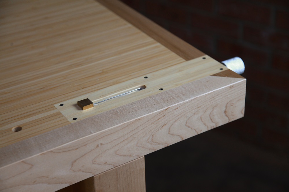 An HNT Gordon tail vice is perfectly fitted to a rock maple and bamboo workbench.