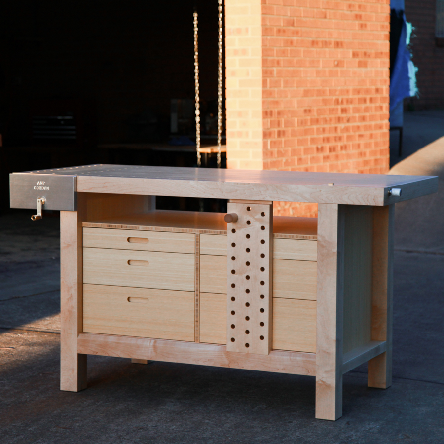 A beautiful woodworking bench catches the evening winter sun out the front of a workshop.